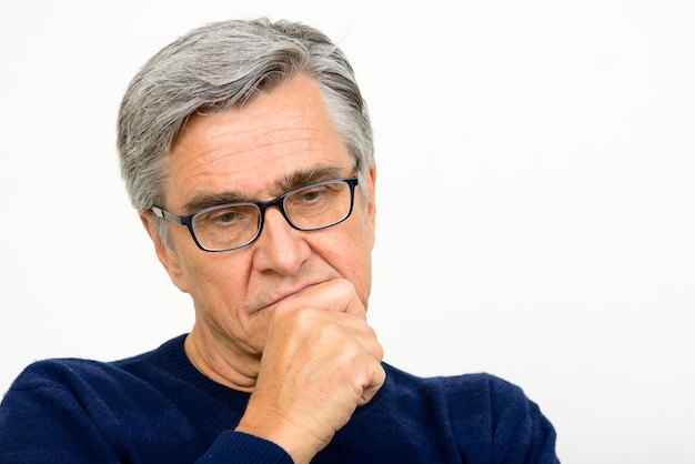 Face of serious senior man with eyeglasses thinking