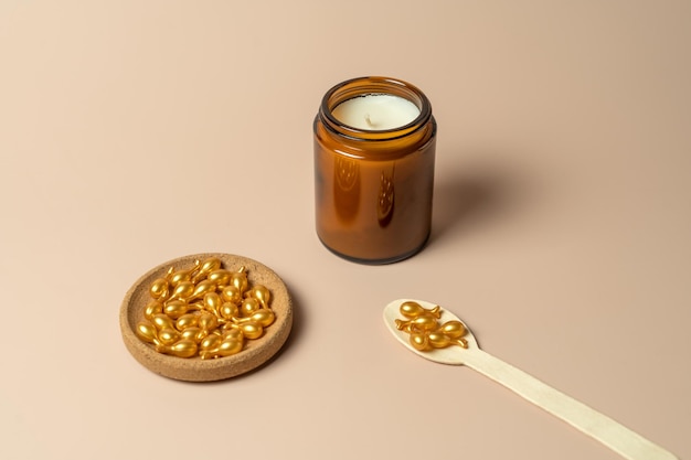 A face serum or oil in golden capsules lying on a beige background