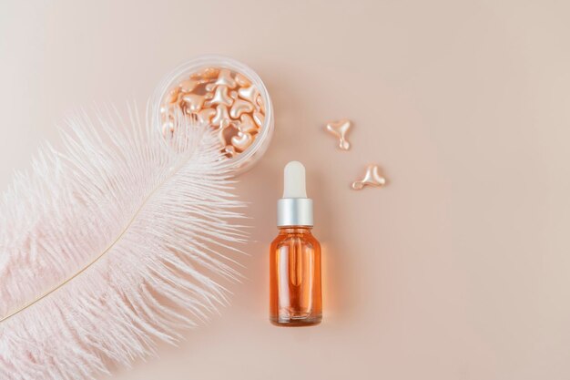 A face serum in pink capsules in the form of heart lying on a pink background