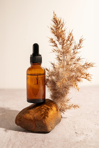 Face serum and skincare product or essential oil in a glass bottle