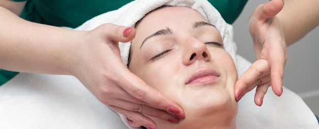 Face skin care Beautician applying beauty oil mask on face using brush In spa salon