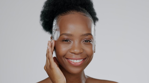 face skincare and hands of happy black woman in studio isolated on gray background mockup space portrait natural cosmetics and african model touch skin in spa facial treatment wellness or health
