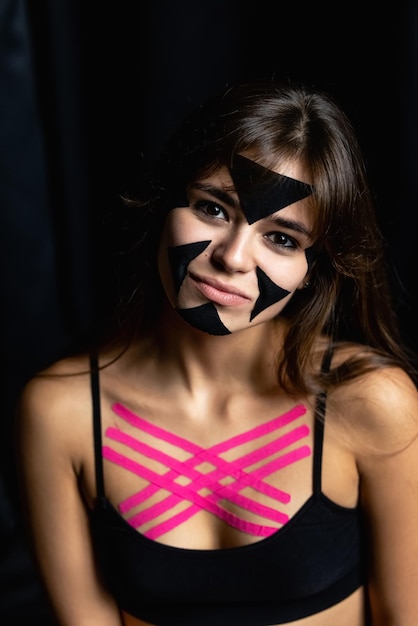 Face taping beautiful girls face with cosmetological tape Face aesthetic taping antiaging lifting method for reduction of wrinkles elastic therapeutic tape Eliminate wrinkles Skin care