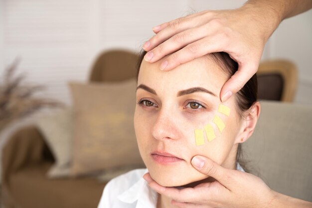 Face taping, close-up of a woman face with cosmetological anti-wrinkle tape. Face aesthetic taping.