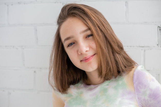 Face of a teenage girl in close up. Teen with problematic skin. Girl with a square hairstyle. Acne and scars. Natural portrait. No makeup and retouch. High quality photo