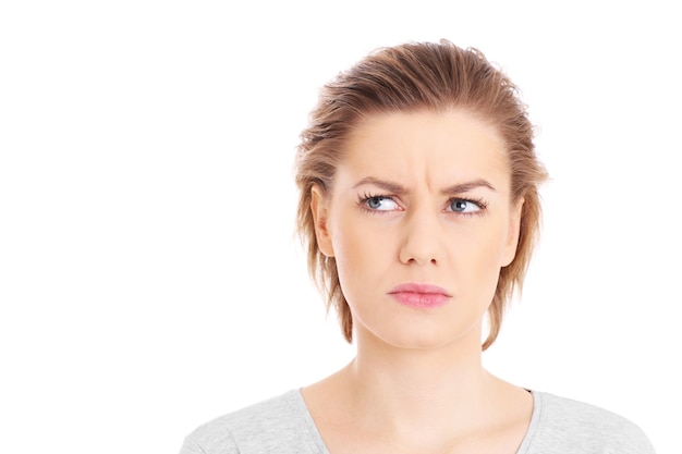 a face of a worried woman posing over white background