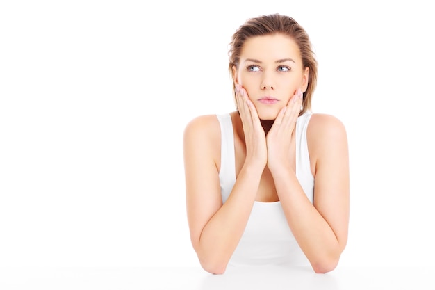 a face of a worried woman posing over white background