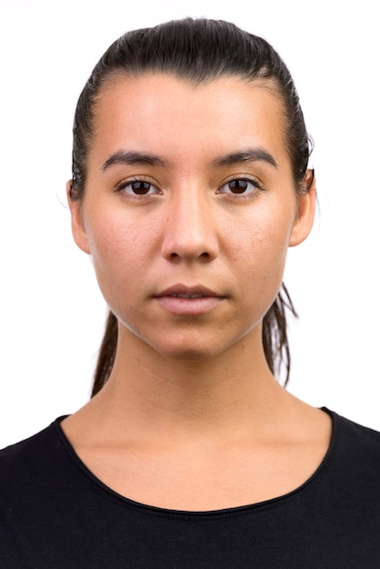 Face of young beautiful Caucasian woman with hair tied back isolated on white