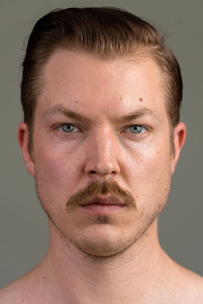 Face of Young Caucasian man shirtless looking at camera