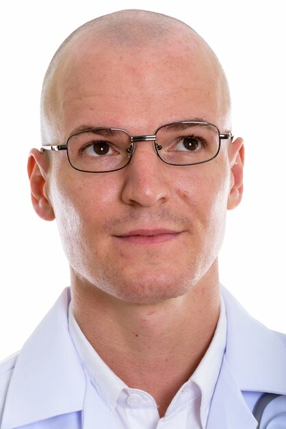 Face of young handsome bald man doctor thinking while wearing eyeglasses