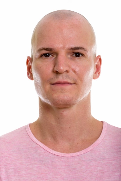 Face of young handsome bald man looking at camera