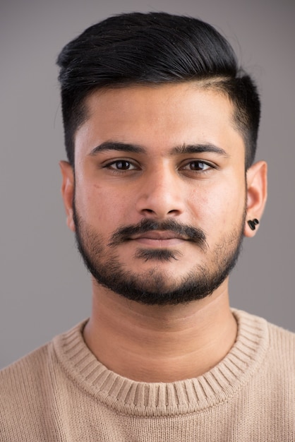 Face of young handsome Indian man