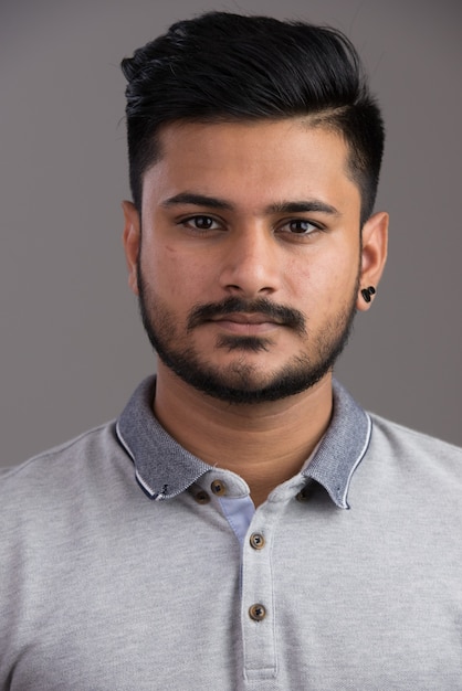 Face of young handsome Indian man