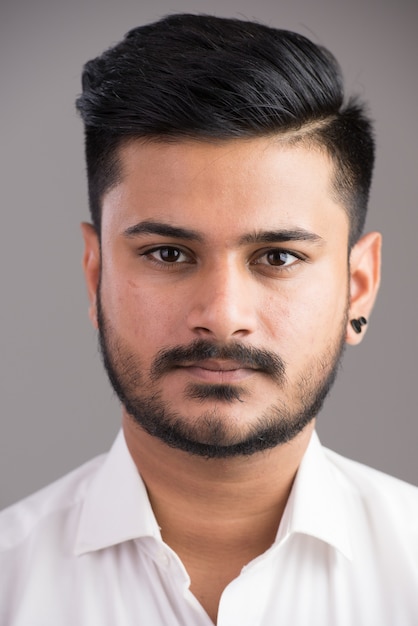 Face of young handsome Indian man