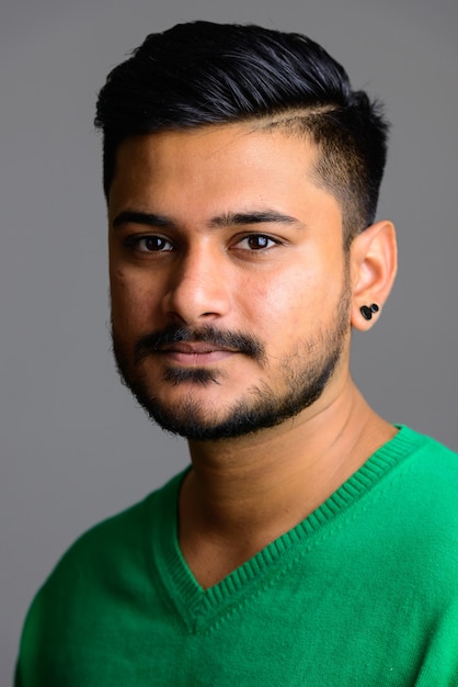 Face of young handsome Indian man