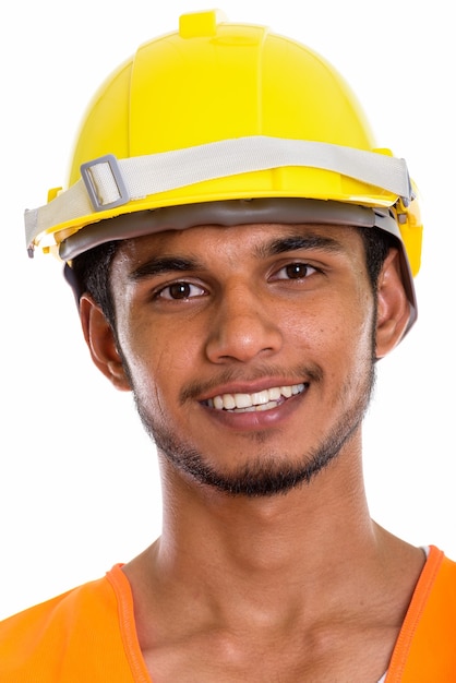 Лицо молодого счастливого индийского рабочего-строителя улыбается