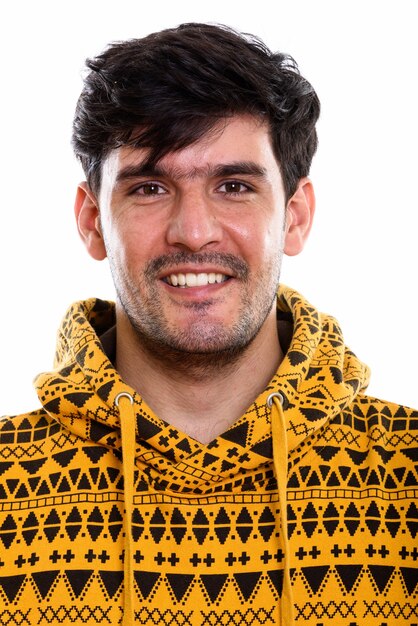 Face of young happy Persian man smiling while wearing hoodie