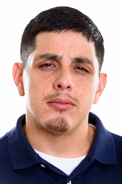 Face of young Hispanic man looking mad isolated on white