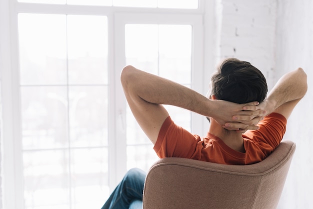 Photo faceless man relaxing in armchair