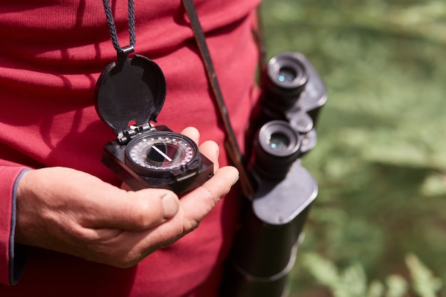 Faceless photo of man's hand with compass