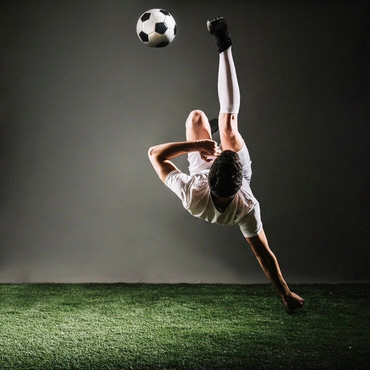 Photo faceless sportsman falling and kicking ball