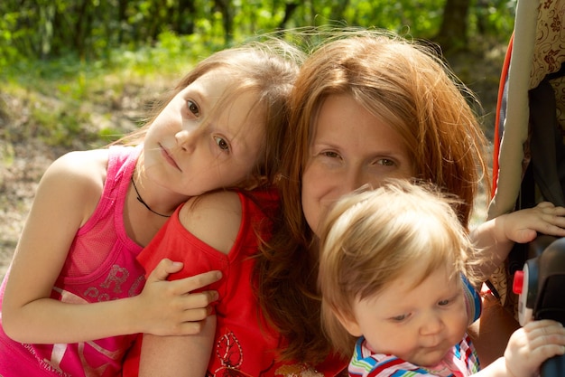 Faces of mother and her daughters outdoor