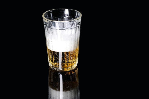 Faceted beer glass on a black background silhouette of a white\
beer mug lines on a black background