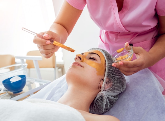 Facial cosmetic procedure in spa salon.