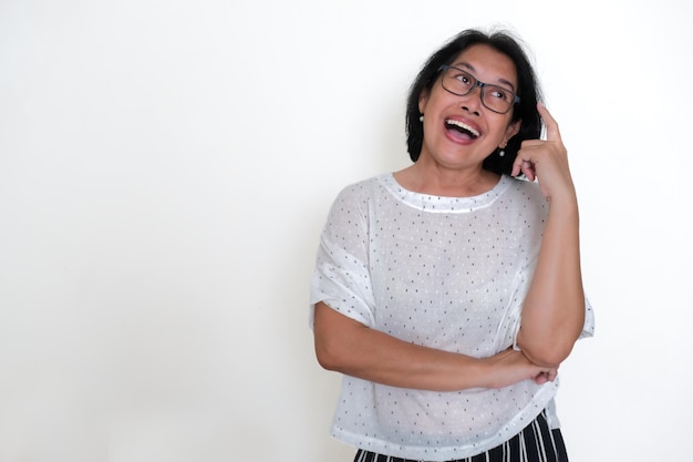 Facial expression of an Asian woman finding a solution standing alone over white background