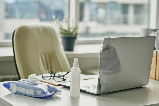 Facial mask, sanitizer, wet wipes are everything necessary for coronavirus prevention at workplace in office