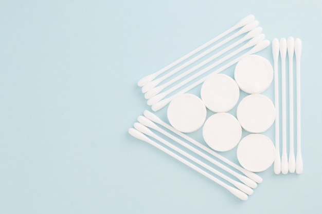 Facial mask sheets compressed type and White cotton buds on blue background 