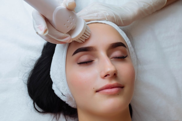 Facial massage care skin brushing spa procedure and cosmetology