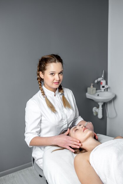 facial massage of young woman receiving spa massage in beauty spa. cosmetology.