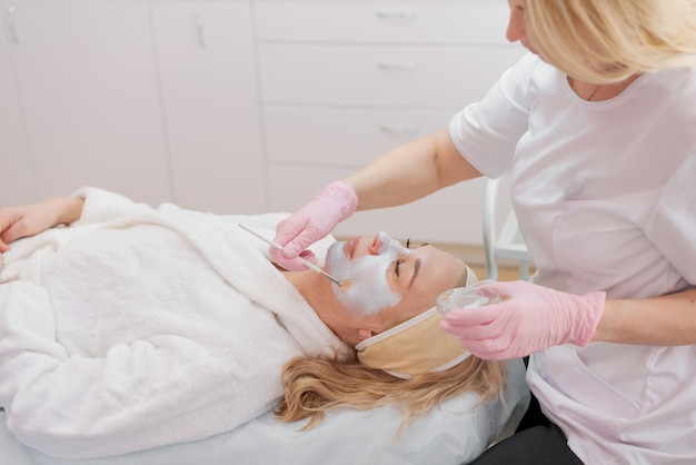 Facial peeling mask beauty spa skin care woman getting facial\
treatment