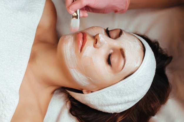 Facial rejuvenation treatment with cream at the spa