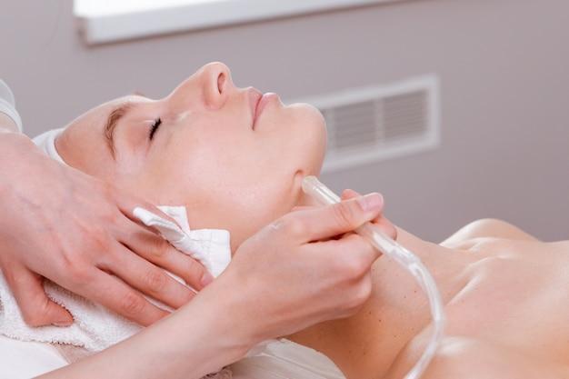 Facial treatment. Beauty face care, gas-liquid procedure for woman over 30. Skin care concept.