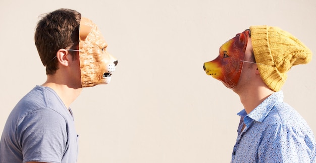 Facing off Two young hipsters facing off while wearing animal masks