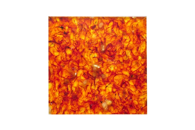 Facing tiles of different colors from amber stone with a beautiful textured pattern on a white background in the light with different angles and a shadow