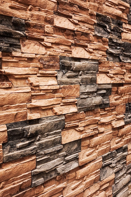 Facing tiles on the wall of the house on the street in Tbilisi