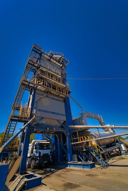 Factory for asphalt production on blue sky background