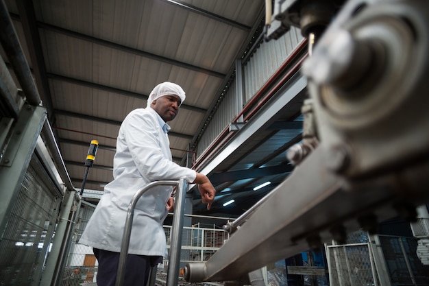 Photo factory engineer monitoring production line