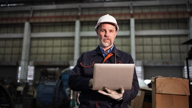 Factory engineer using laptop in the factory