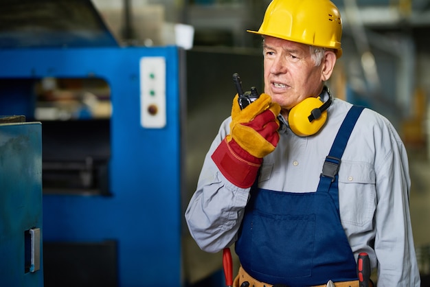 Factory Foreman Speaking by Radio Set