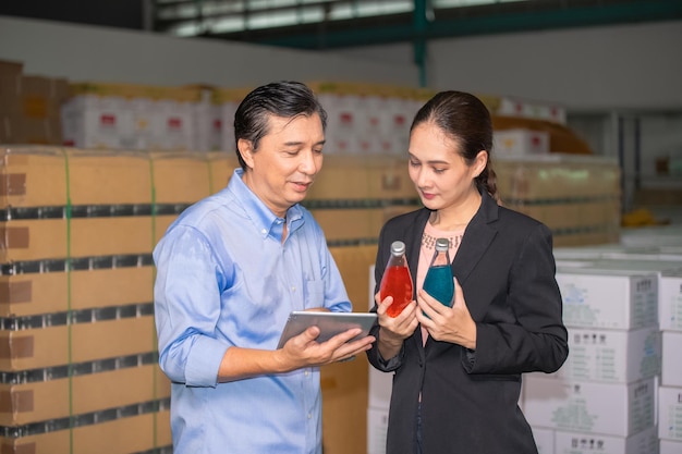 Factory manager talking with quality control team in food\
factory for food quality business export to customer factory\
manager with worker employee checking inventory in stock\
wearhouse