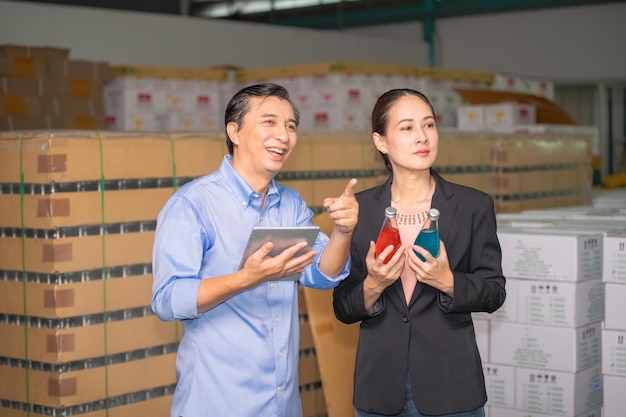 Factory manager talking with quality control team in food factory for food quality business export to customer Factory manager with worker employee checking inventory in stock Wearhouse
