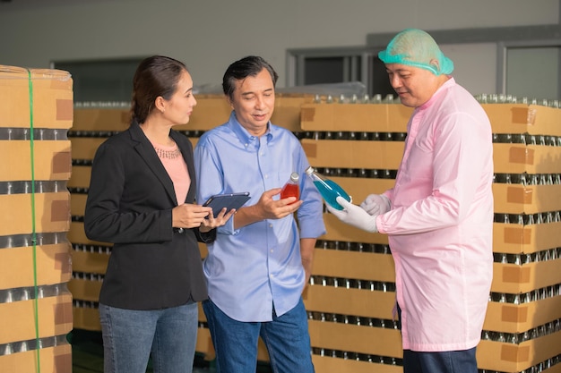 Factory manager talking with quality control team in food\
factory for food quality business export to customer factory\
manager with worker employee checking inventory in stock\
wearhouse