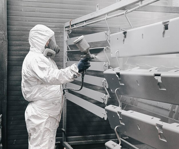 Factory staff wear chemical protective clothing at work paint
spraying