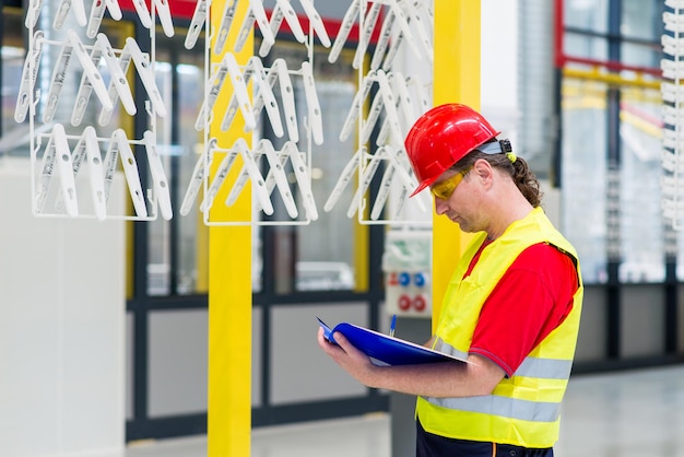 Photo factory supervisor checking production line for quality control