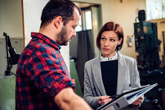 Factory supervisor talking with dissatisfied employees