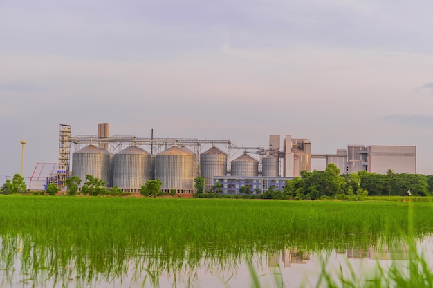 Factory with a green field.